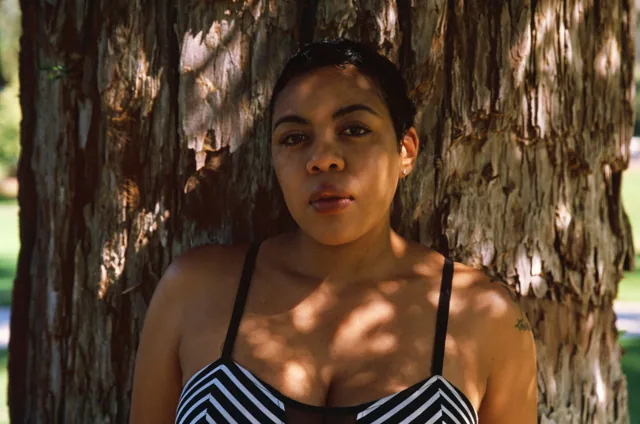 Camisha in front of tree