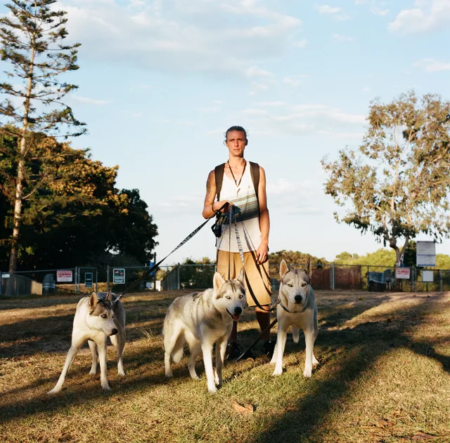 Man and three huskies