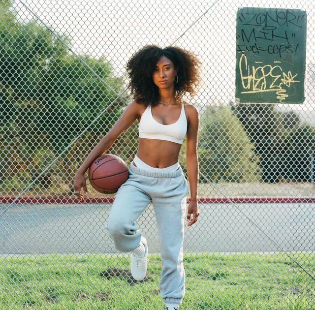 Christina standing with a basketball